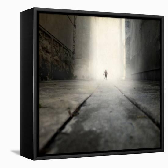 A Low Level View of a Boy Running Along the Street-Luis Beltran-Framed Stretched Canvas