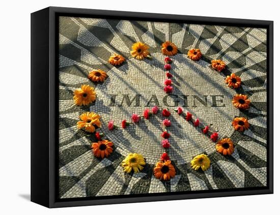 A Makeshift Peace Sign of Flowers Lies on Top John Lennon's Strawberry Fields Memorial-null-Framed Stretched Canvas