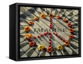 A Makeshift Peace Sign of Flowers Lies on Top John Lennon's Strawberry Fields Memorial-null-Framed Stretched Canvas