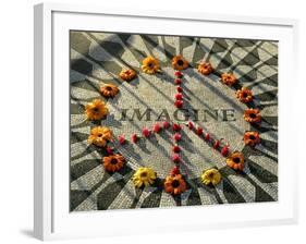 A Makeshift Peace Sign of Flowers Lies on Top John Lennon's Strawberry Fields Memorial-null-Framed Photographic Print