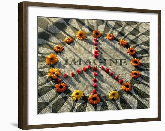 A Makeshift Peace Sign of Flowers Lies on Top John Lennon's Strawberry Fields Memorial-null-Framed Photographic Print