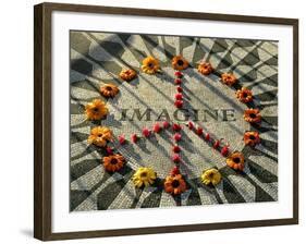 A Makeshift Peace Sign of Flowers Lies on Top John Lennon's Strawberry Fields Memorial-null-Framed Photographic Print