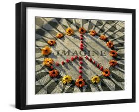 A Makeshift Peace Sign of Flowers Lies on Top John Lennon's Strawberry Fields Memorial-null-Framed Photographic Print