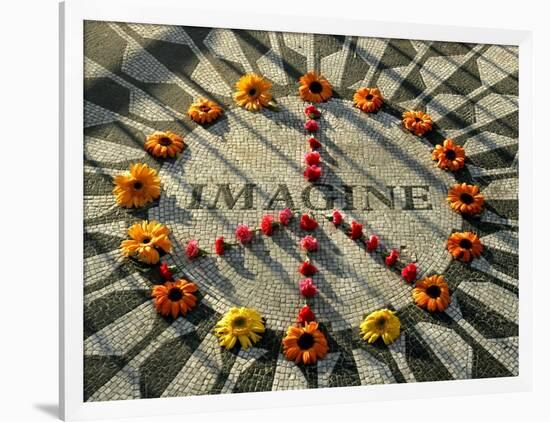 A Makeshift Peace Sign of Flowers Lies on Top John Lennon's Strawberry Fields Memorial-null-Framed Photographic Print