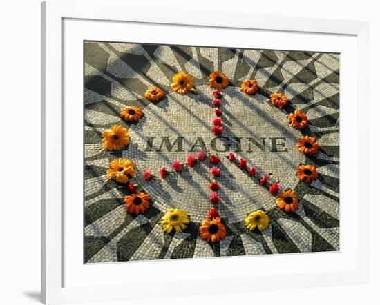 A Makeshift Peace Sign of Flowers Lies on Top John Lennon's Strawberry Fields Memorial-null-Framed Photographic Print