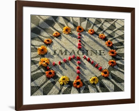 A Makeshift Peace Sign of Flowers Lies on Top John Lennon's Strawberry Fields Memorial-null-Framed Photographic Print