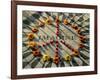 A Makeshift Peace Sign of Flowers Lies on Top John Lennon's Strawberry Fields Memorial-null-Framed Photographic Print