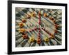 A Makeshift Peace Sign of Flowers Lies on Top John Lennon's Strawberry Fields Memorial-null-Framed Photographic Print