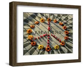 A Makeshift Peace Sign of Flowers Lies on Top John Lennon's Strawberry Fields Memorial-null-Framed Photographic Print