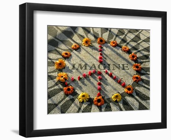 A Makeshift Peace Sign of Flowers Lies on Top John Lennon's Strawberry Fields Memorial-null-Framed Photographic Print