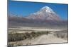 A Man Cycles in the Shadow of Sajama Volcano in Sajama National Park-Alex Saberi-Mounted Photographic Print