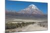 A Man Cycles in the Shadow of Sajama Volcano in Sajama National Park-Alex Saberi-Mounted Photographic Print