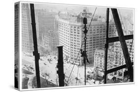 A Man Hangs Precariously from a Line During the Construction of a Skyscraper in New York-null-Stretched Canvas