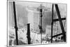 A Man Hangs Precariously from a Line During the Construction of a Skyscraper in New York-null-Mounted Photographic Print