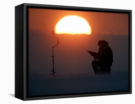 A Man Icefishes on the Frozen Finnish Gulf at Sunset Outside St.Petersburg-null-Framed Stretched Canvas