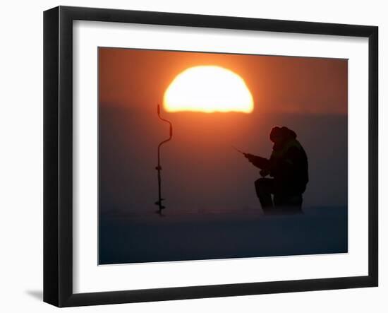 A Man Icefishes on the Frozen Finnish Gulf at Sunset Outside St.Petersburg-null-Framed Photographic Print