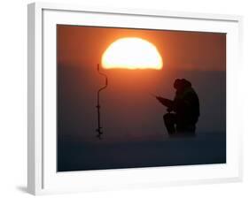 A Man Icefishes on the Frozen Finnish Gulf at Sunset Outside St.Petersburg-null-Framed Photographic Print