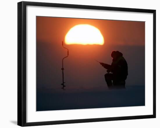 A Man Icefishes on the Frozen Finnish Gulf at Sunset Outside St.Petersburg-null-Framed Photographic Print