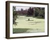 A Man in a Row Boat Drifts on the Louisiana Bayou-null-Framed Photographic Print