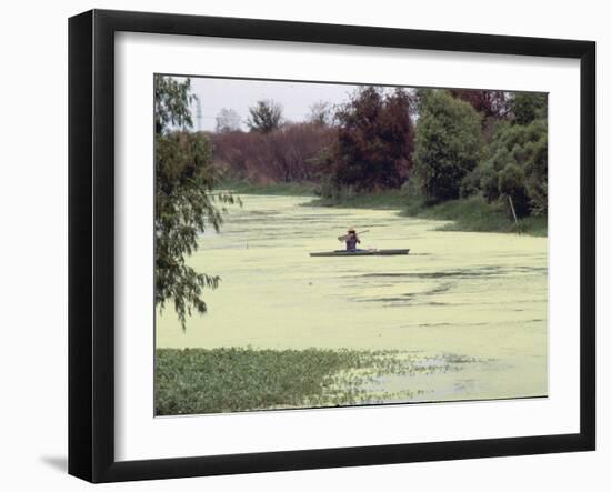 A Man in a Row Boat Drifts on the Louisiana Bayou-null-Framed Photographic Print