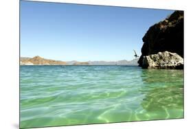 A Man Jumps into a Bay Near Loreto, Baja Sur, Mexico-Bennett Barthelemy-Mounted Photographic Print