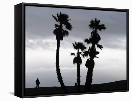 A Man Looks out Towards the Ocean as a Winter Rain Storm Falls on Seal Beach-null-Framed Stretched Canvas