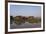 A man paddles his canoe past one of the floating villages on Inle Lake, Myanmar (Burma), Asia-Alex Treadway-Framed Photographic Print