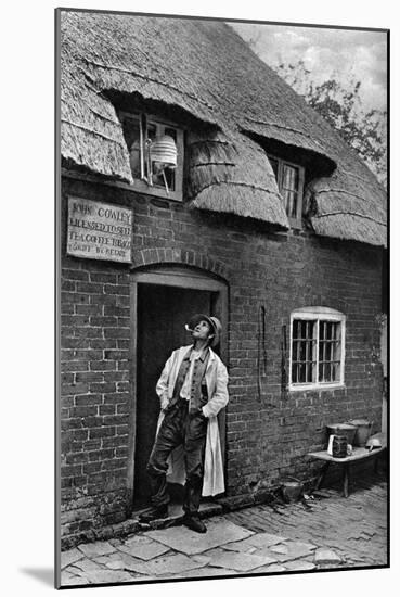 A Man Smoking a Pipe Outside a Shop, Worcestershire, C1922-AW Cutler-Mounted Giclee Print