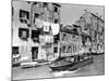A Man Takes His Boat Through the Canal-null-Mounted Photographic Print