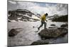 A Man Uses His Trekking Poles to Hop across a Lake in the Southern Wind River Range in Wyoming-Sergio Ballivian-Mounted Photographic Print