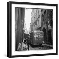 A Man Walks His Dog Beside a Bus with Coca Cola Advertisement, France, 1950-Mark Kauffman-Framed Photographic Print