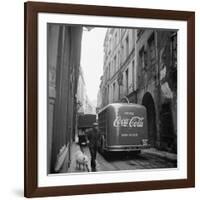 A Man Walks His Dog Beside a Bus with Coca Cola Advertisement, France, 1950-Mark Kauffman-Framed Photographic Print