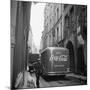 A Man Walks His Dog Beside a Bus with Coca Cola Advertisement, France, 1950-Mark Kauffman-Mounted Photographic Print