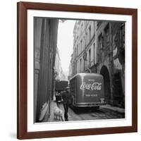 A Man Walks His Dog Beside a Bus with Coca Cola Advertisement, France, 1950-Mark Kauffman-Framed Photographic Print