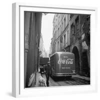 A Man Walks His Dog Beside a Bus with Coca Cola Advertisement, France, 1950-Mark Kauffman-Framed Photographic Print