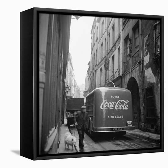 A Man Walks His Dog Beside a Bus with Coca Cola Advertisement, France, 1950-Mark Kauffman-Framed Stretched Canvas