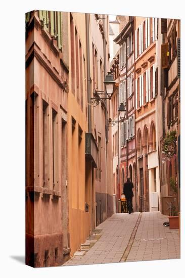 A Man Walks Through La Petite France-Julian Elliott-Stretched Canvas