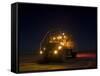 A Maxxpro MRAP Vehicle with Running Lights on at Night-null-Framed Stretched Canvas