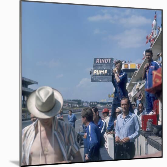 A Mechanic Holding Up a Sign, French Grand Prix, Le Mans, France, 1967-null-Mounted Photographic Print