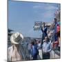 A Mechanic Holding Up a Sign, French Grand Prix, Le Mans, France, 1967-null-Mounted Photographic Print