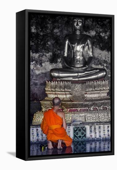 A Monk Prays in Front of a Golden Buddha, Wat Suthat, Bangkok, Thailand, Southeast Asia, Asia-Andrew Taylor-Framed Stretched Canvas