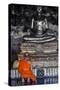 A Monk Prays in Front of a Golden Buddha, Wat Suthat, Bangkok, Thailand, Southeast Asia, Asia-Andrew Taylor-Stretched Canvas