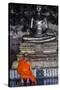 A Monk Prays in Front of a Golden Buddha, Wat Suthat, Bangkok, Thailand, Southeast Asia, Asia-Andrew Taylor-Stretched Canvas