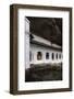 A Monk Sits and Looks at His Phone Beneath Shelter-Charlie-Framed Photographic Print