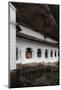 A Monk Sits and Looks at His Phone Beneath Shelter-Charlie-Mounted Photographic Print