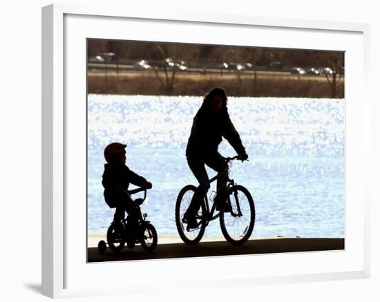 A Mother and Son are Silhouetted as They Ride Along the Schuylkill River-null-Framed Photographic Print