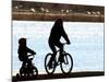 A Mother and Son are Silhouetted as They Ride Along the Schuylkill River-null-Mounted Photographic Print