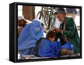 A Mother Watches as Her Child Gets a Haircut in the Center of Kabul, Afghanistan on Oct. 9, 2003.-null-Framed Stretched Canvas