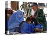 A Mother Watches as Her Child Gets a Haircut in the Center of Kabul, Afghanistan on Oct. 9, 2003.-null-Stretched Canvas