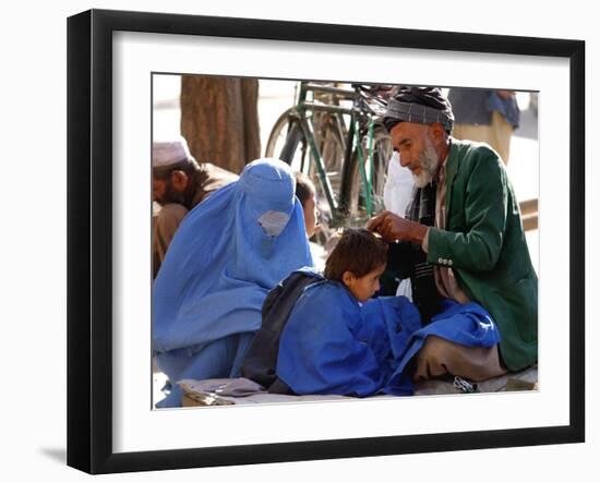 A Mother Watches as Her Child Gets a Haircut in the Center of Kabul, Afghanistan on Oct. 9, 2003.-null-Framed Photographic Print